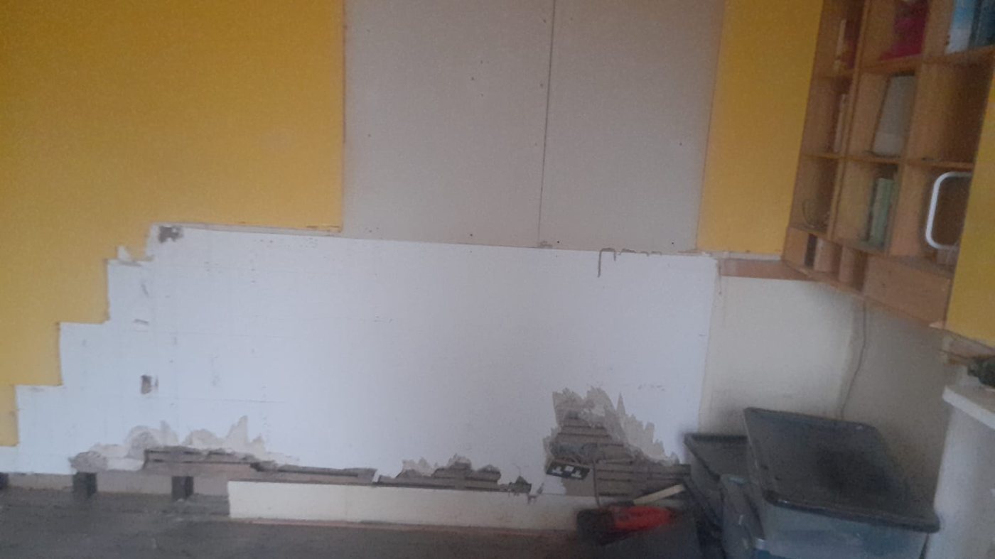 Kitchen wall stripped back to plaster during a refit