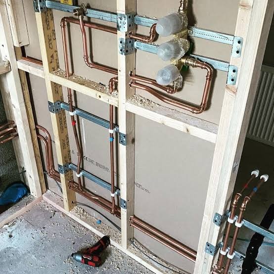 Copper pipework run through a stud wall at first fix