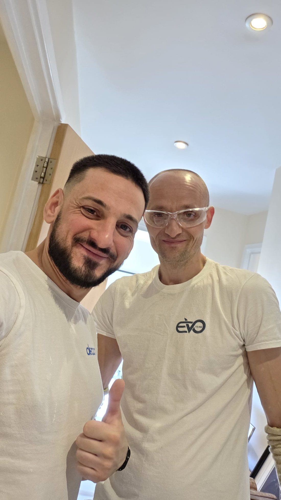 John Zaman and a member of the team on a finished job in East London